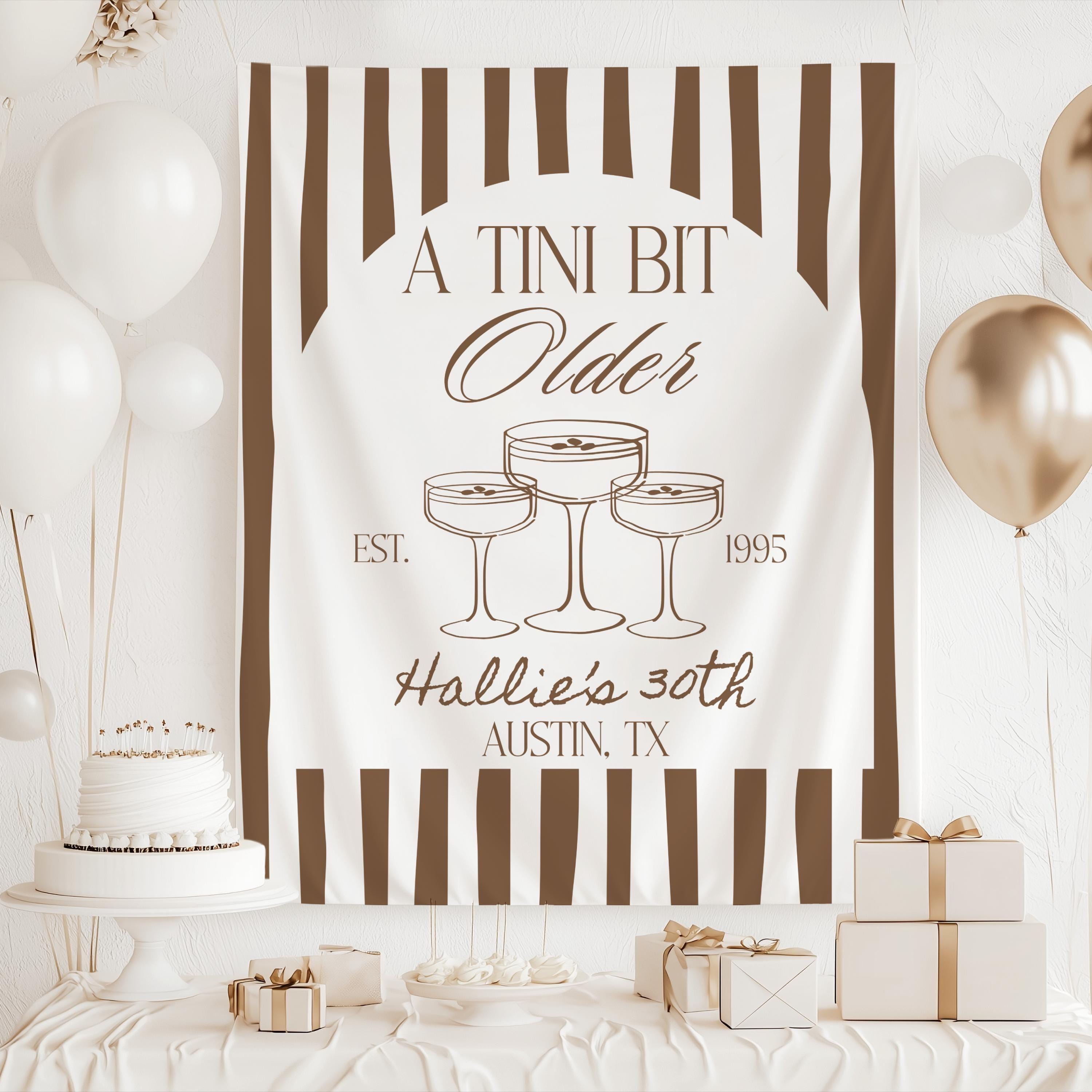 A Tini Bit Older personalized birthday party backdrop with martini cocktail illustrations
