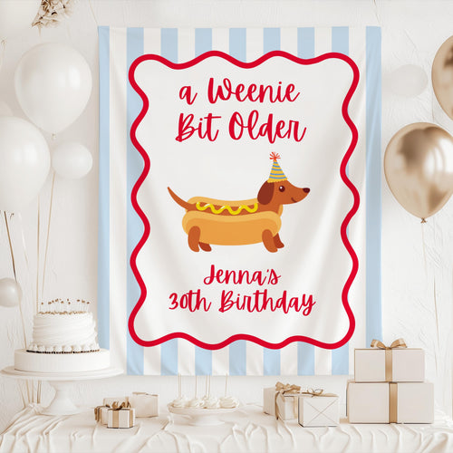 Funny A Weenie Bit Older birthday party backdrop with dachshund hot dog artwork and personalized name
