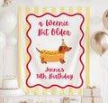 Personalized A Weenie Bit Older birthday banner featuring a dachshund hot dog illustration with custom birthday text
