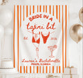 Personalized Bride in a Tajini Bit bachelorette party banner featuring striped design, swimsuit illustration and custom names for a beach bach celebration.