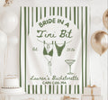 Personalized Bride in a Tini Bit banner featuring dirty martini artwork, striped design, hanging bikini illustration, and custom bachelorette details.