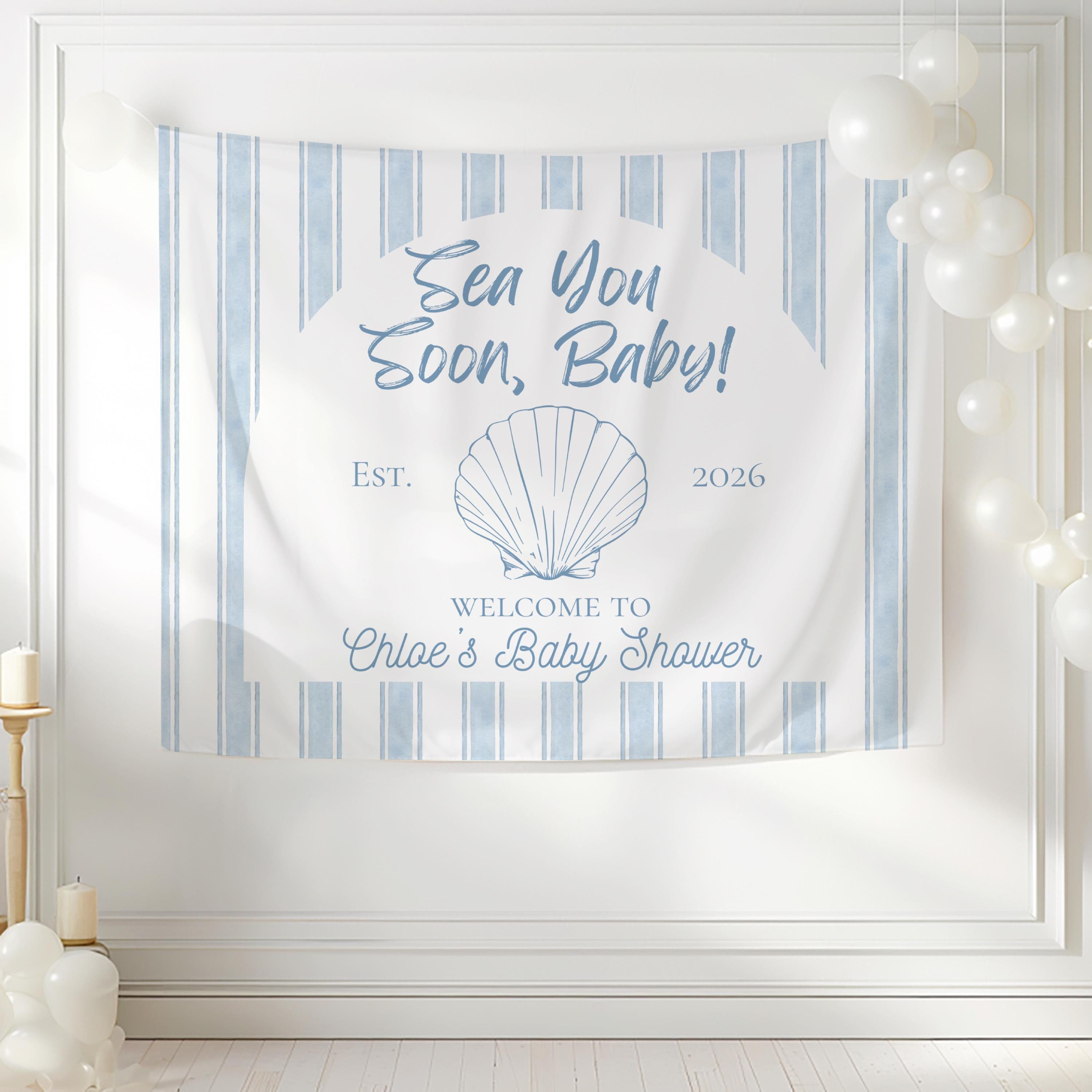 Custom beach baby shower backdrop featuring blue stripes and seashell artwork with personalized text