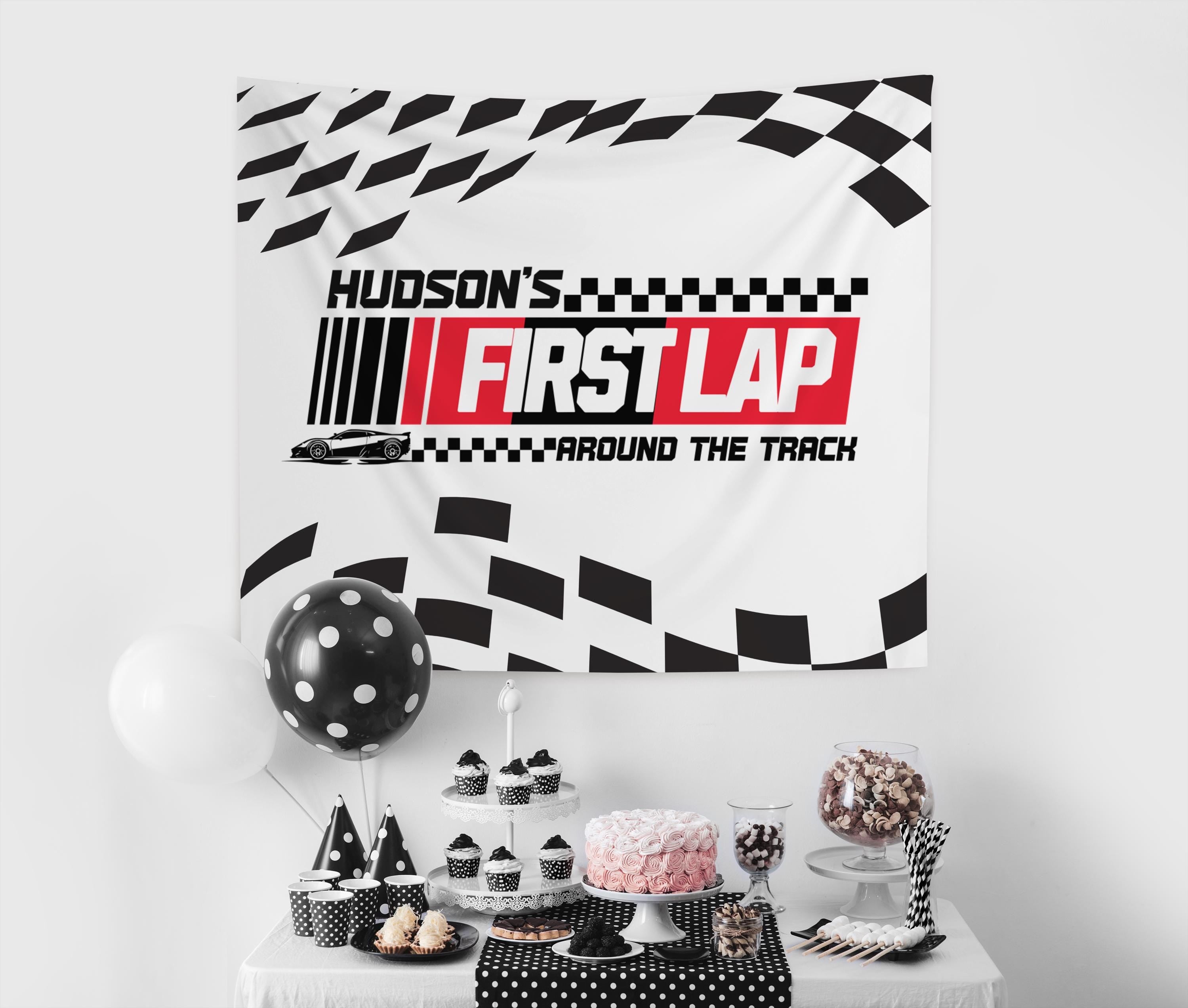 Fast One birthday banner featuring race track graphics and checkered flag artwork for a first birthday celebration
