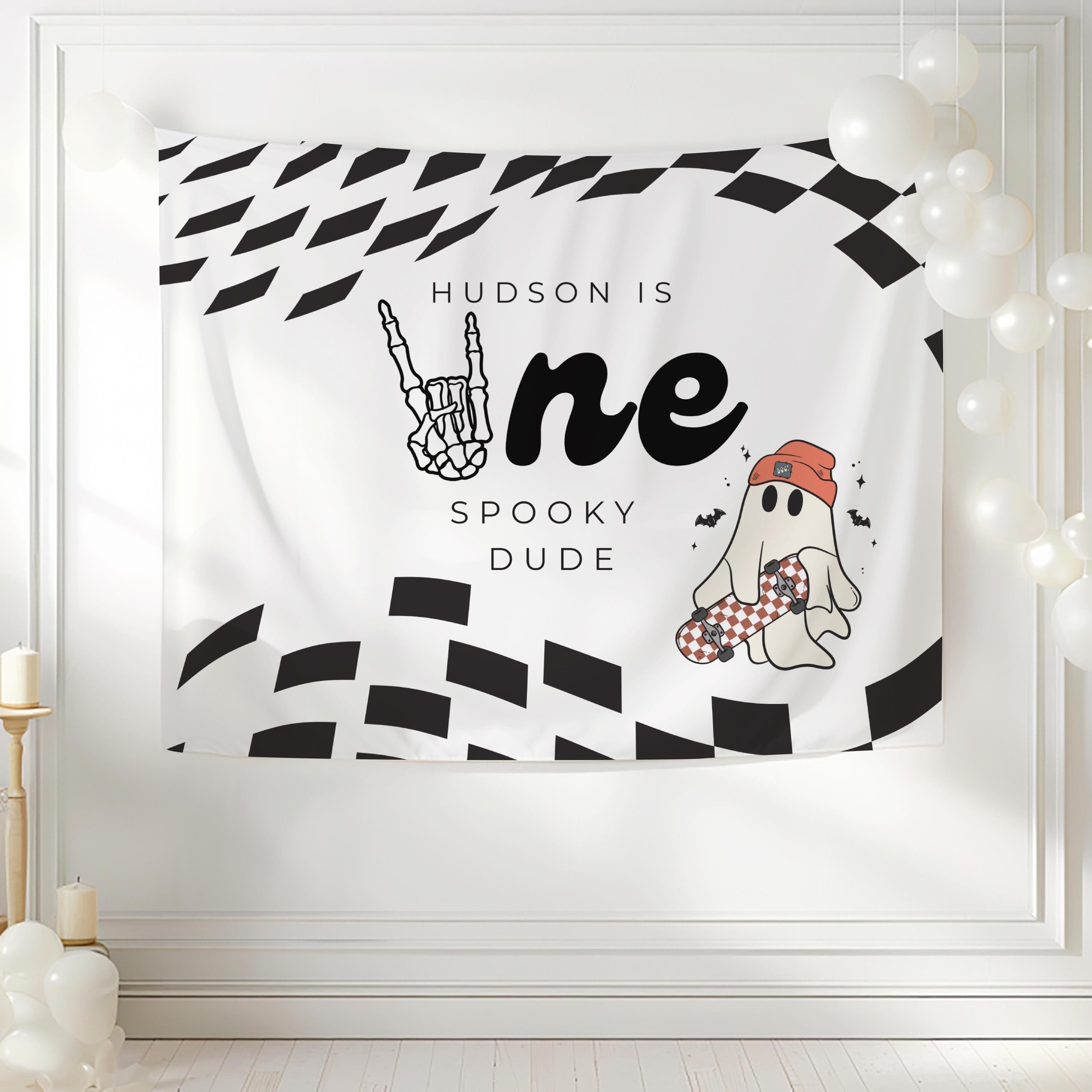 Custom Halloween first birthday backdrop featuring a cute ghost skateboard and personalized party details
