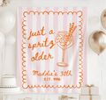 Personalized Just a Spritz Older birthday banner with pink striped background and orange spritz cocktail illustration
