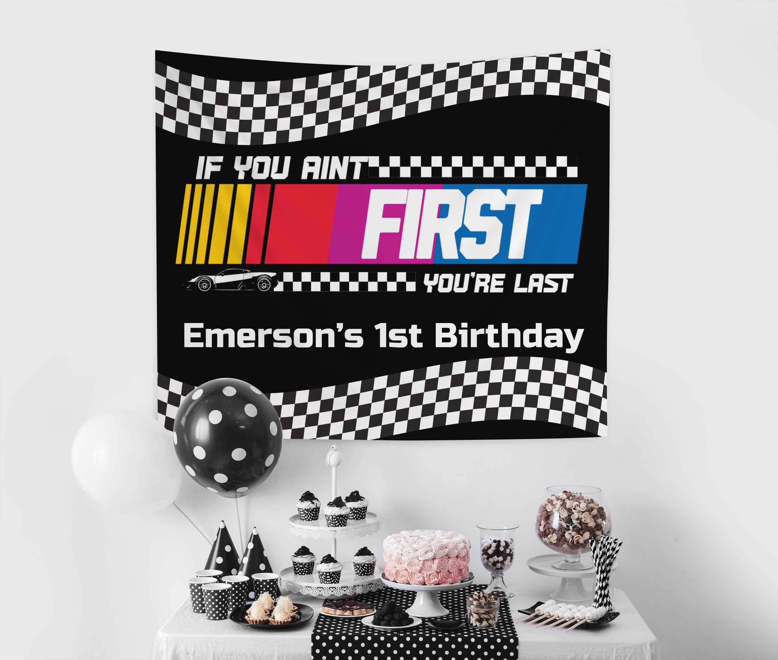 Personalized racing birthday backdrop designed for first birthdays with checkered flags and custom name.