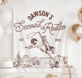 Personalized Second Rodeo birthday banner featuring a cowboy riding a bucking horse with western desert artwork and custom birthday details.