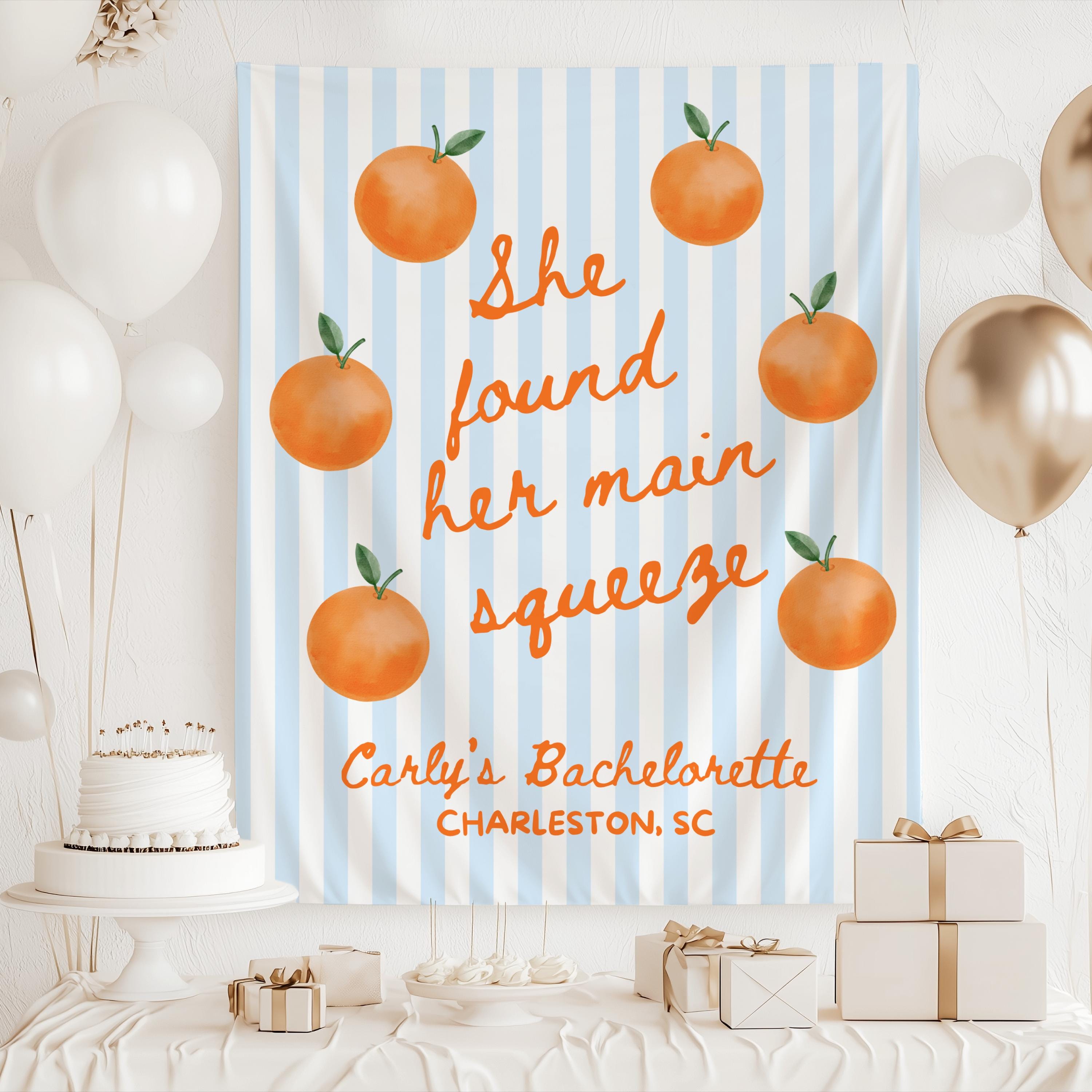 She Found Her Main Squeeze bridal shower backdrop featuring an orange citrus design and personalized details
