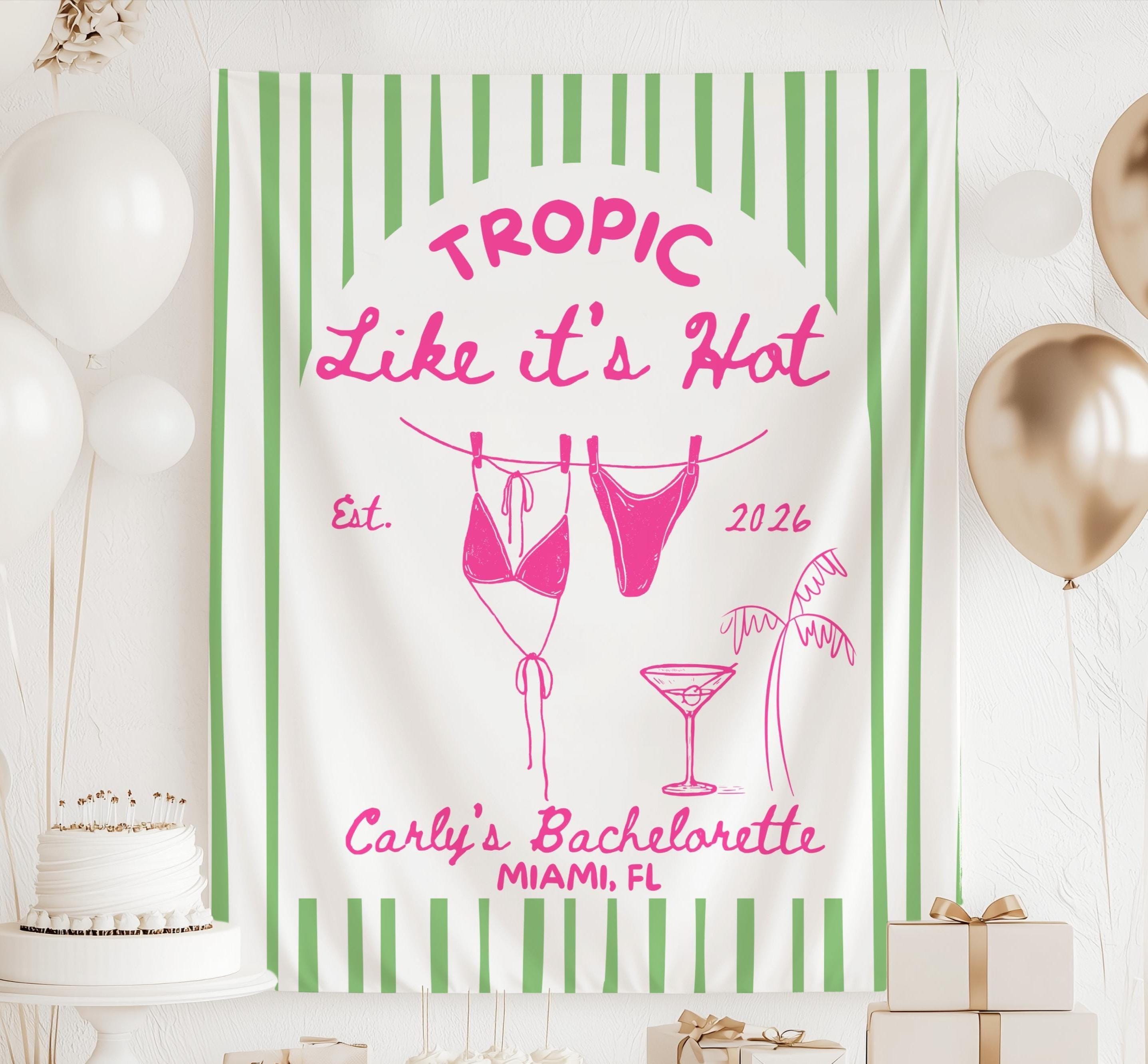 Personalized Tropic Like It's Hot bachelorette banner with striped backdrop, hanging bikini clothesline design and custom names for a tropical beach celebration.
