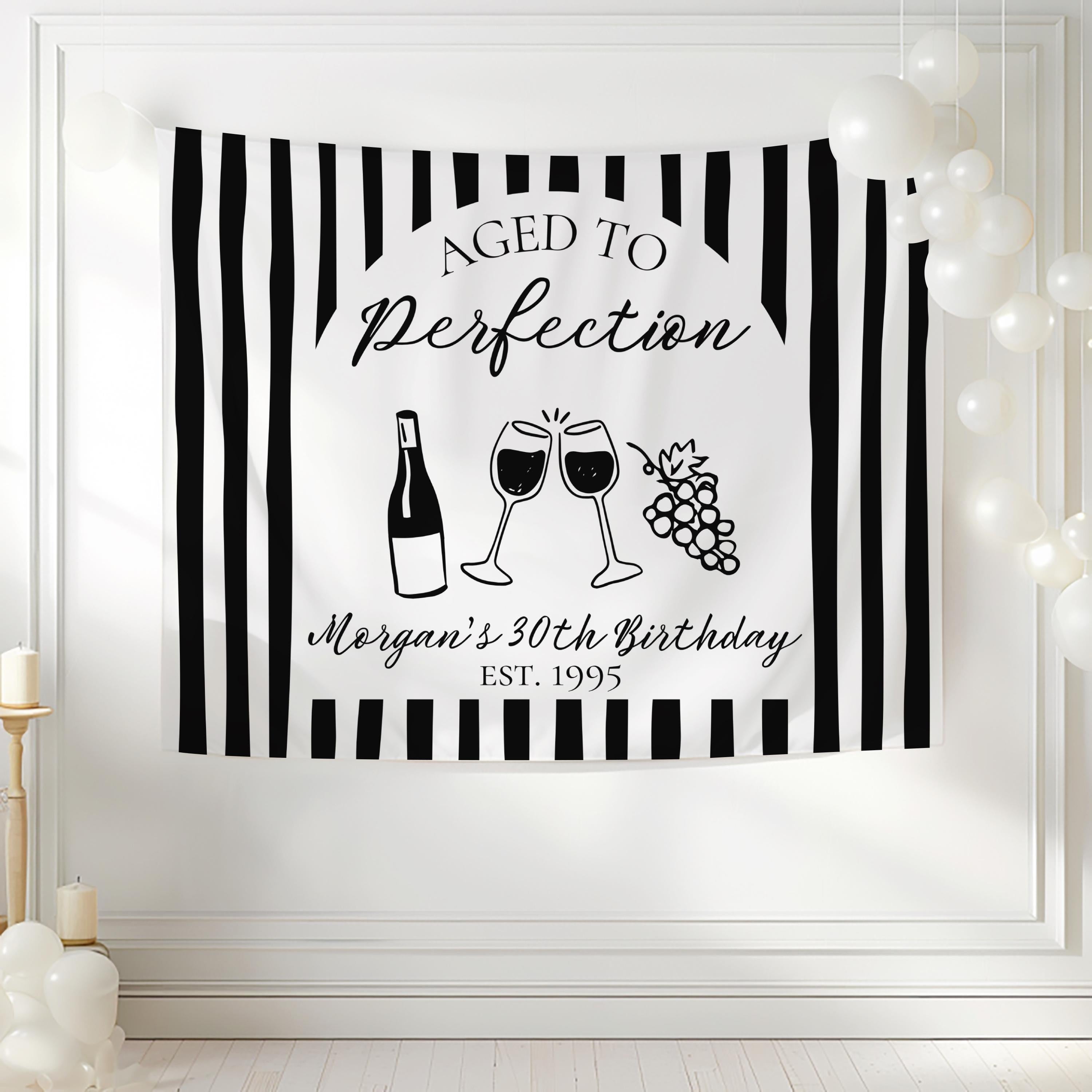 Winery inspired birthday party backdrop with wine glasses bottle and grapes
