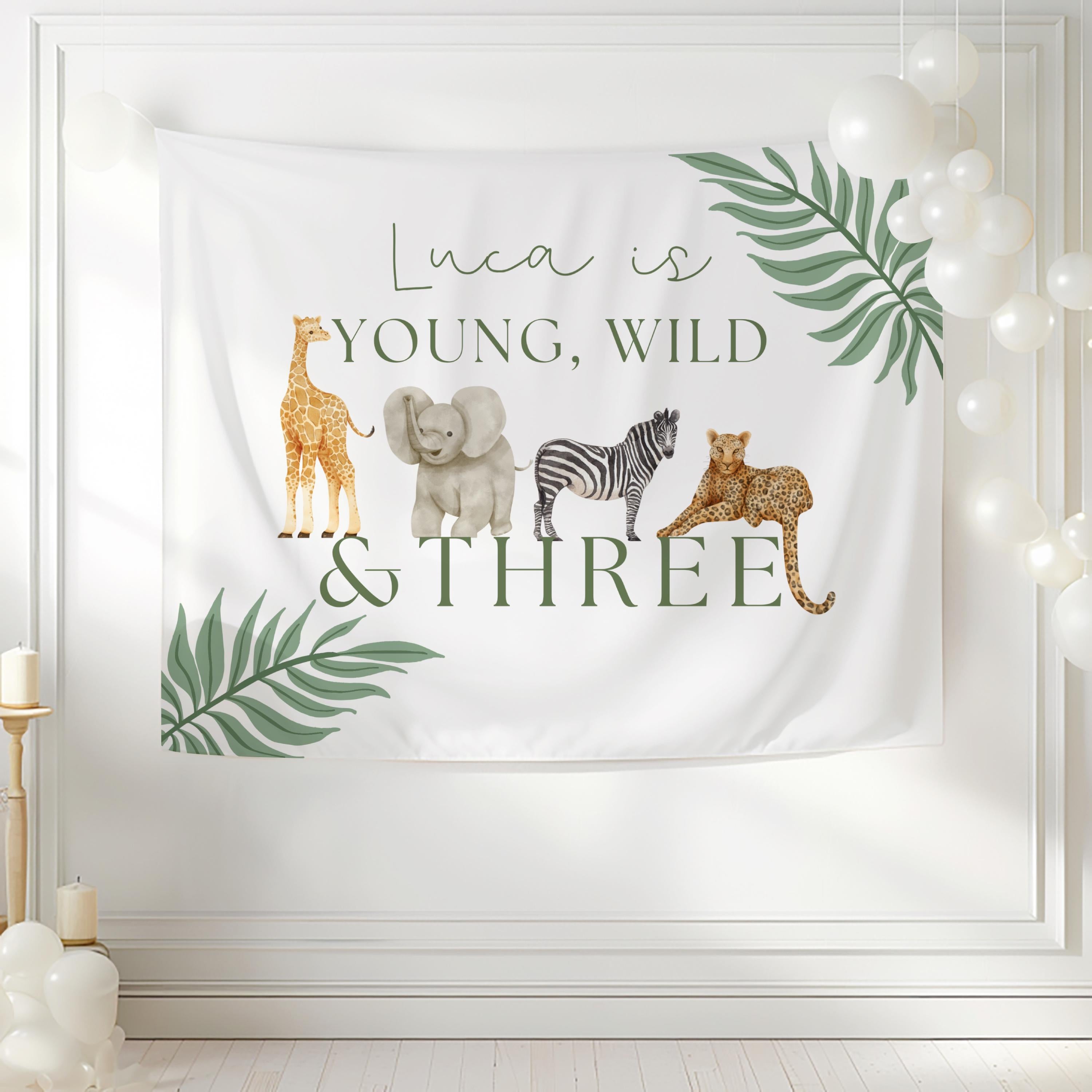 Young, Wild & Three birthday backdrop personalized with child's name for a safari themed third birthday party.